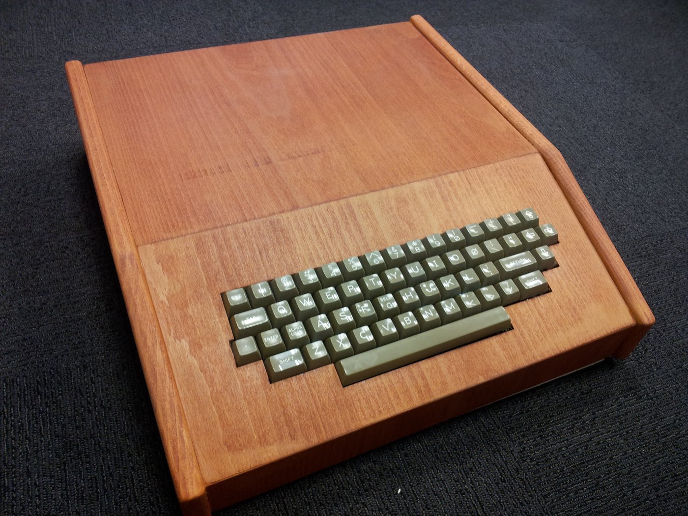 A working replica of the Apple I, the machine Steve Wozniak designed to show off at the Homebrew Computer Club — its built-in keyboard-and-video interface a direct answer to the switch-and-lamp Alt…