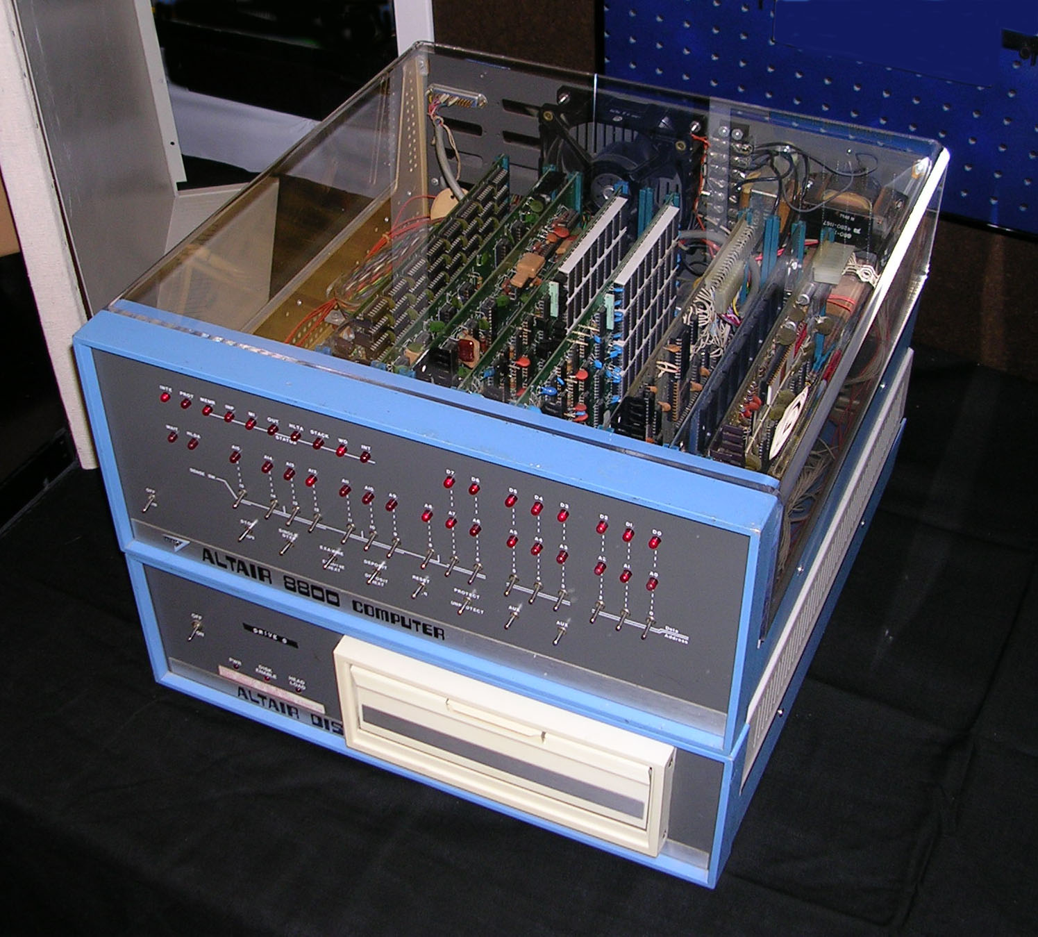 Inside the Altair 8800: the passive backplane stands vertically at the rear with plug-in cards rising from it, the bulky linear power supply filling much of the cabinet, and the front panel at the …