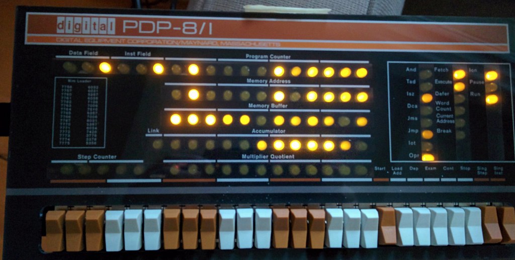 PLACEHOLDER (stock photo, to be replaced with Jeff's own build photo) — a finished, powered PiDP-8/I, the front panel lit and a program running: the register lamps glowing in the same layout as a r…